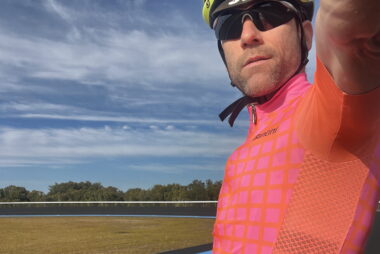 Coach Trent Renshaw cycling in a pink jersey during a pyramid training session at Toormina Velodrome.