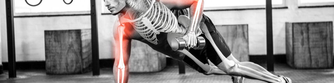 Black and white composite image of a muscular man performing single-arm high planks with hand weights, overlaid with a skeleton illustration and red highlights on the humerus bones to symbolise musculoskeletal strain.