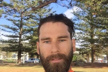 Coach Trent Renshaw with a thick beard wearing cycling apparel during a ride.