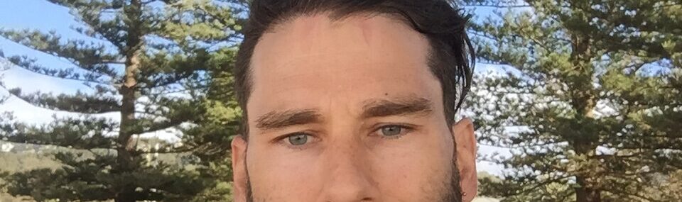 Coach Trent Renshaw with a thick beard wearing cycling apparel during a ride.