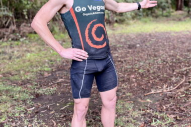 Coach Trent Renshaw in running tights pointing the way during a forest-to-lake run from Blackbutt to Balarang.