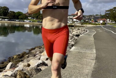 Coach Trent Renshaw performing interval training on the BayRun around Iron Cove, wearing a heart rate belt to monitor performance.