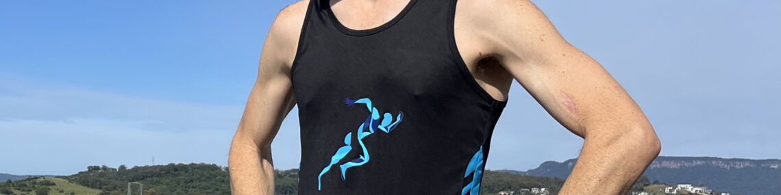 Coach Trent Renshaw standing on a jetty at Lake Illawarra after completing a 10km base run.