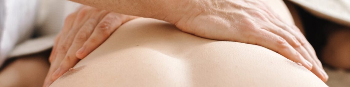 Close-up of hands performing remedial massage on a man’s diaphragm