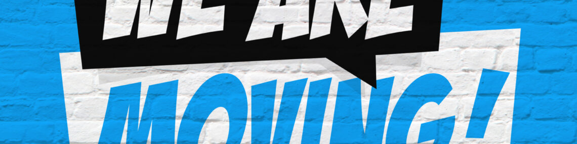 Blue painted brick wall with a black and white speech bubble design containing the words “we are moving!”